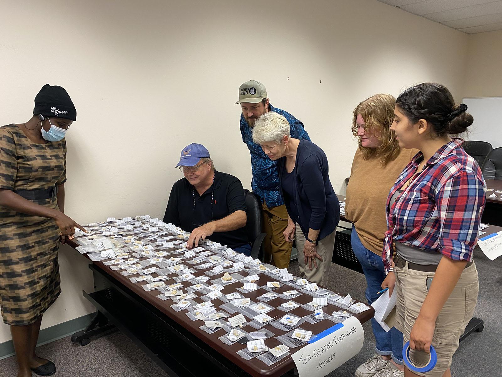Ceramic experts and students looking at various artifacts