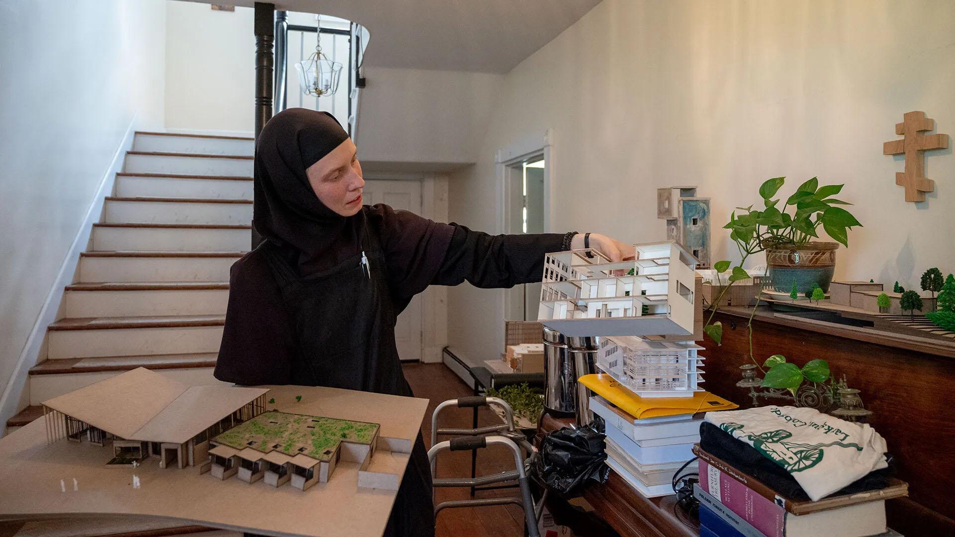 Sister Nina showing architecture models in her monastery