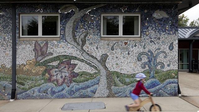 A tree and flower landscape mosaic on a building
