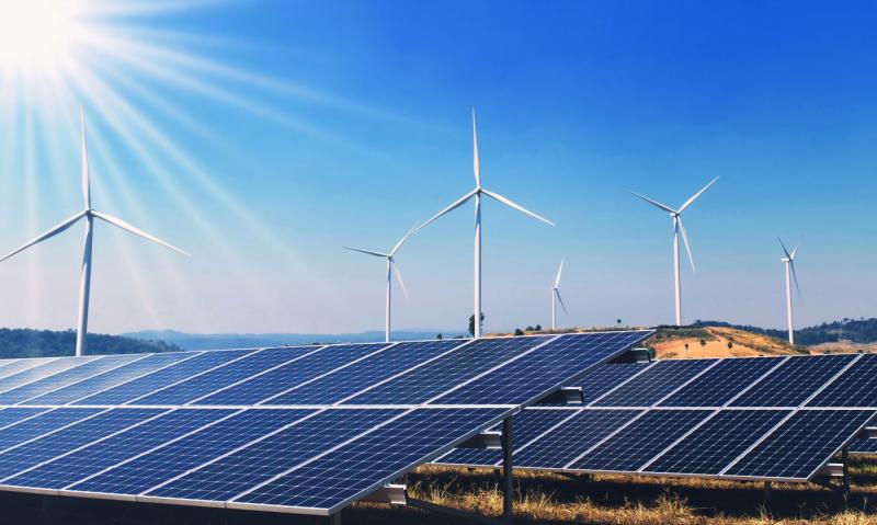 clean energy power in nature. solar panels and wind turbine