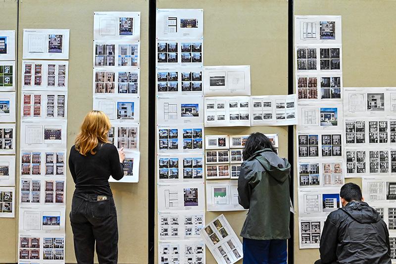 Students pinning up AI architecture iterations