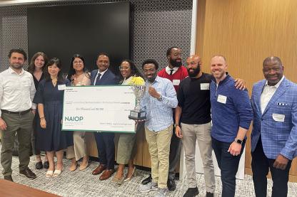 Student winners of the NAIOP challenge posing with a trophy and big check