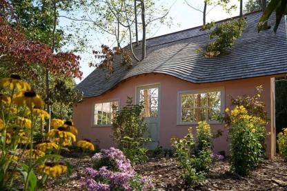Bird blinds house by David Brooks with flowers in the foreground