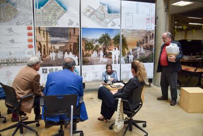 A student showing her Master of Architecture Thesis project model