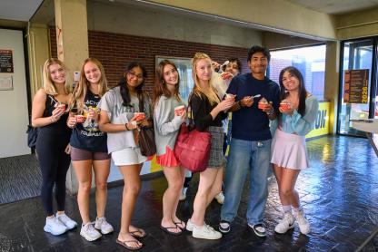 Students posing in the Architecture building with ice cream